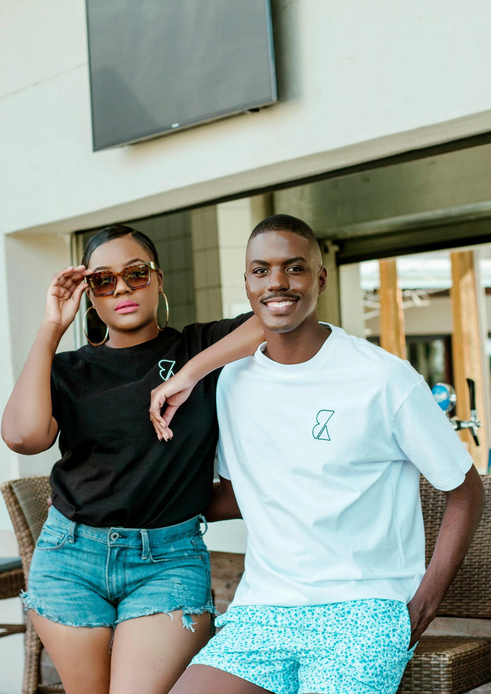 two people wearing white shirts posing for a po