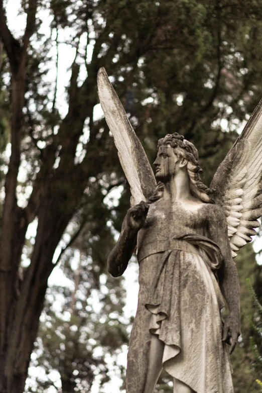 a statue of an angel holding a baseball bat