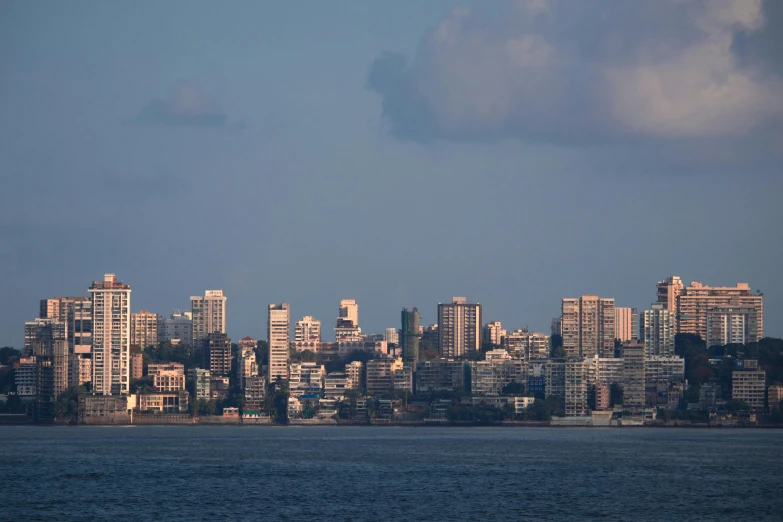 view of a skyline from the sea at dusk