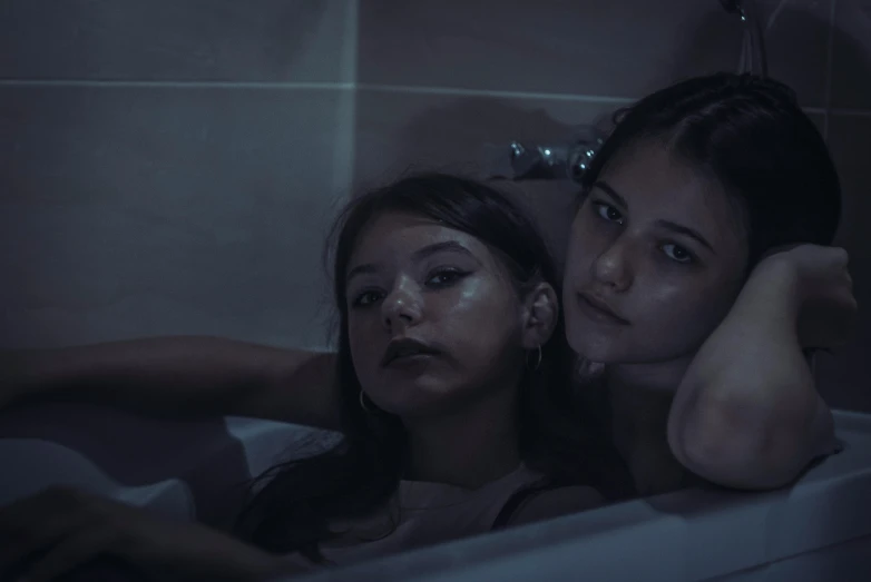 two women relaxing in the bathtub together