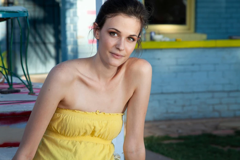 a beautiful woman posing for a po while sitting down