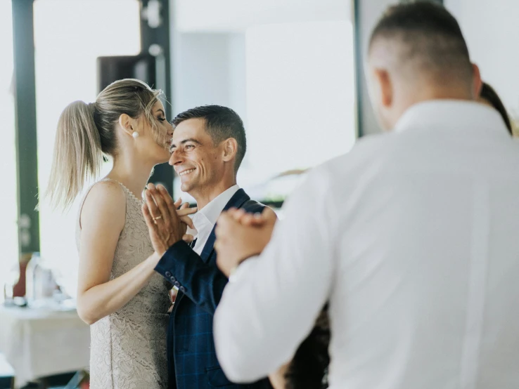 a woman standing next to a man and laughing