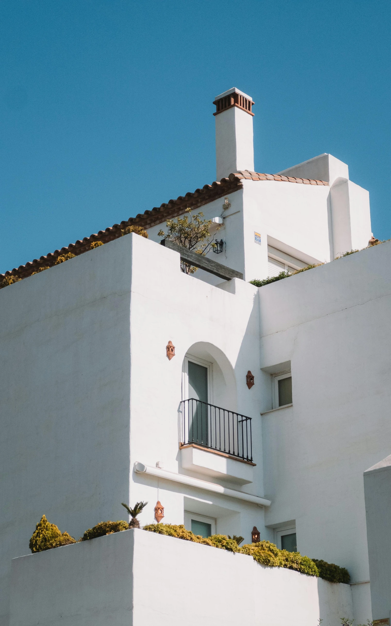 a white building with a balcony and balcony