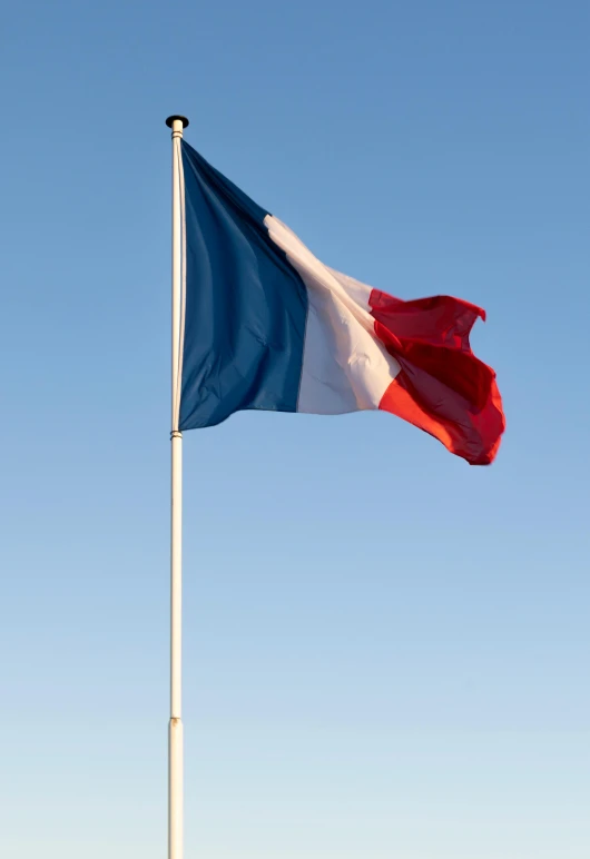 a french flag flies high in the sky