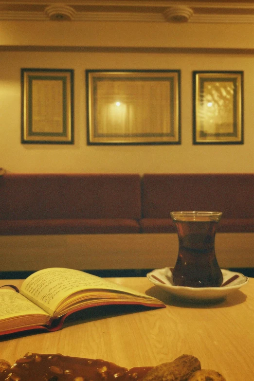 a book, pastry and a cup of coffee sit on a table