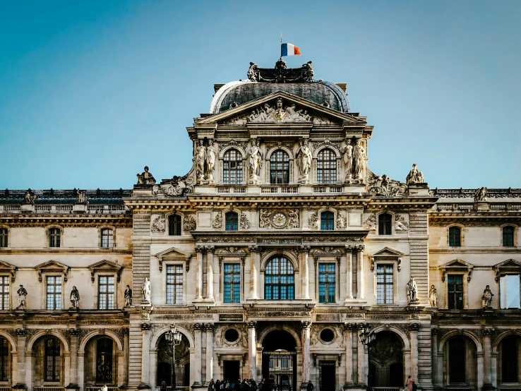 the architecture of a large building with two flags on top