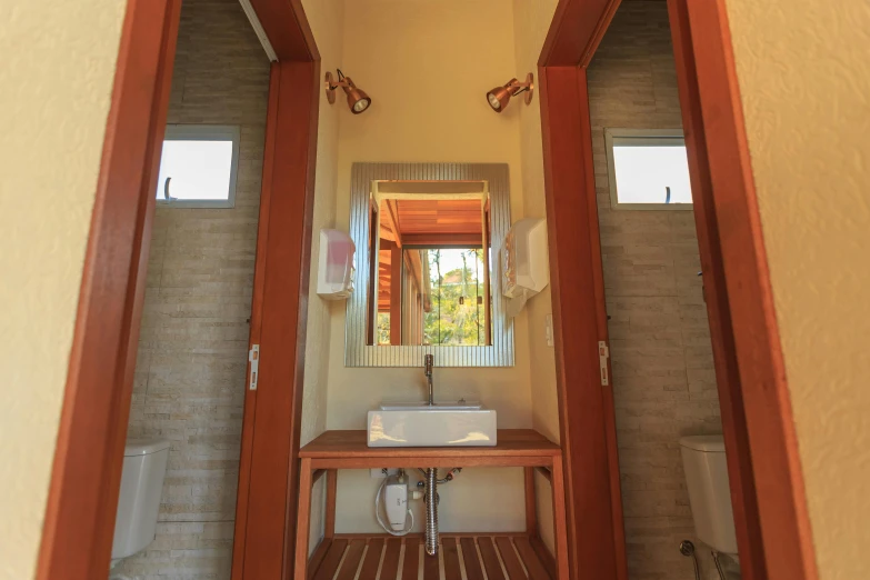 the inside of a bathroom, looking in from across a wooden table