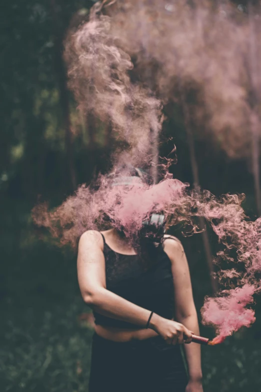 a woman is smoking a pink and black pipe