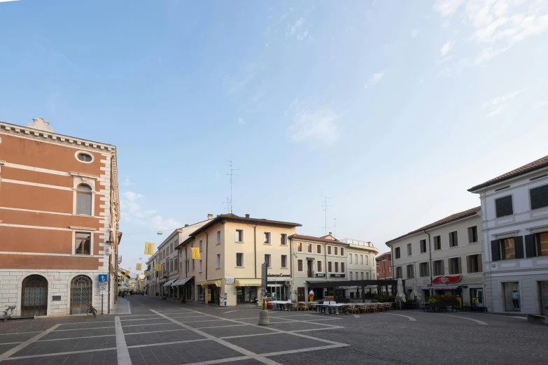 a empty street in a city with buildings around it