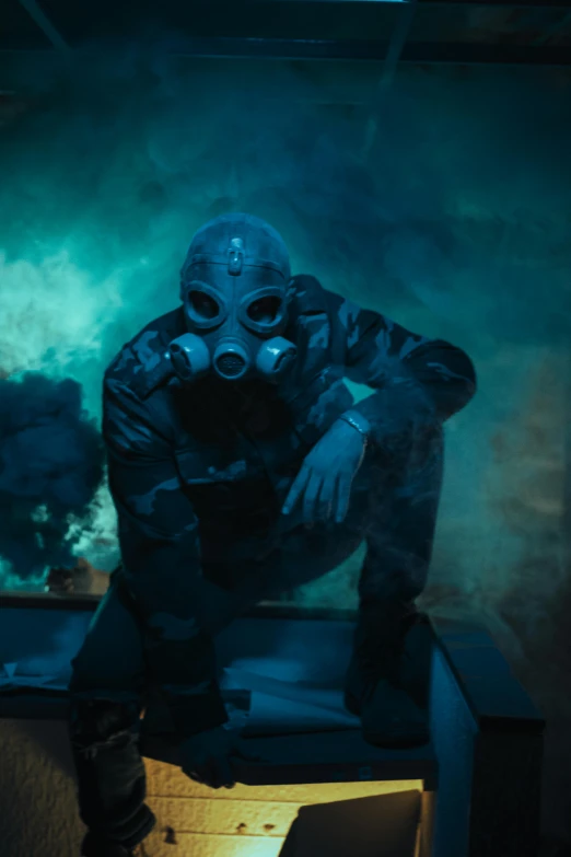 man wearing gas mask crouching in an empty box