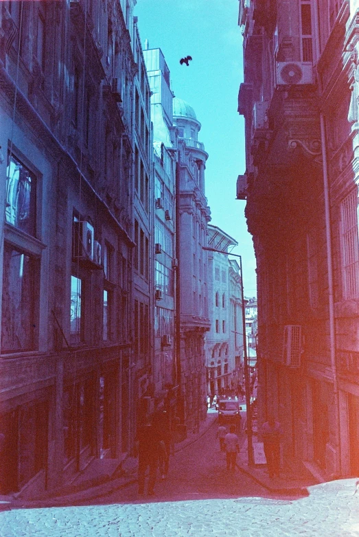 an old picture of several tall buildings on a street