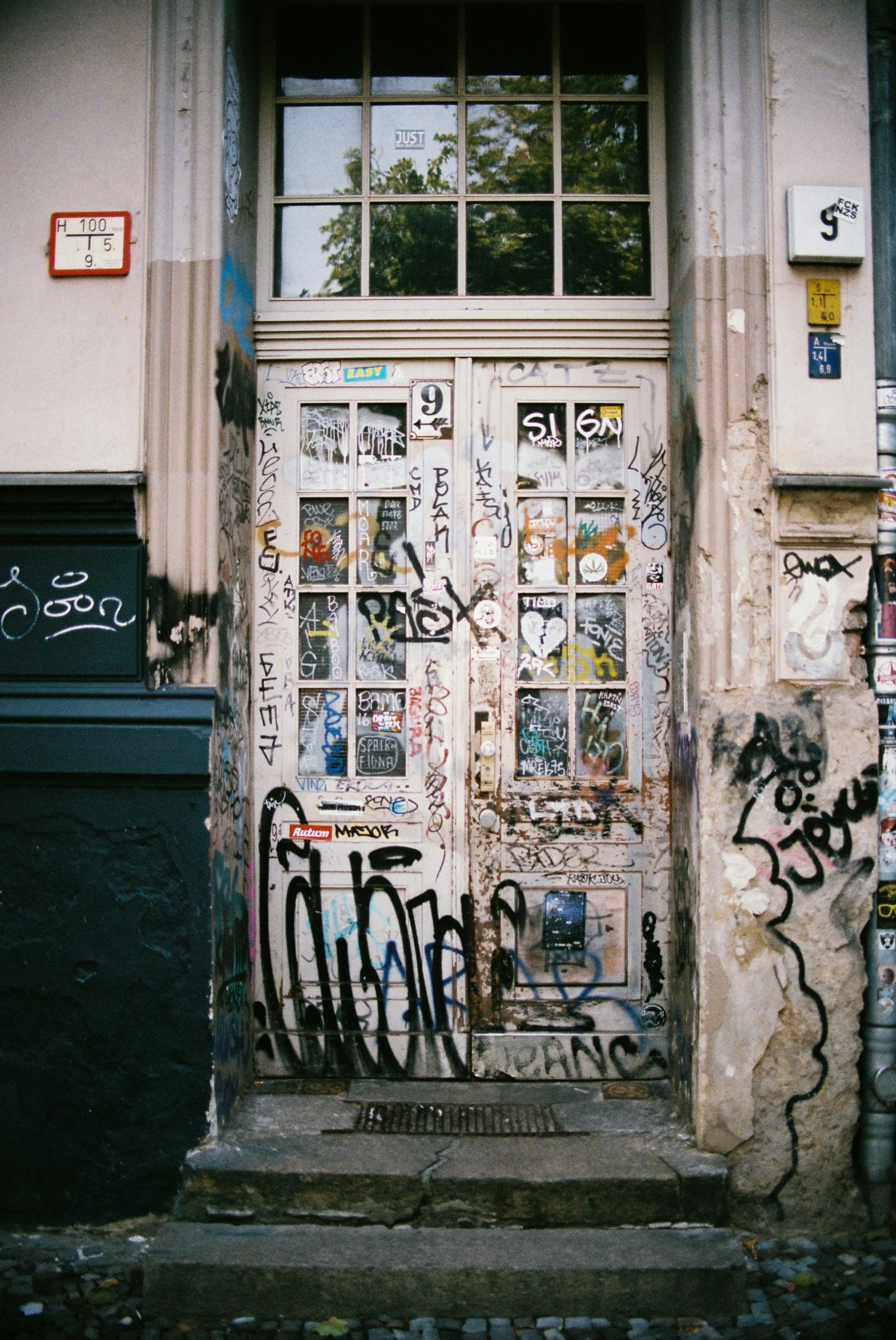 a white door with lots of graffiti on it
