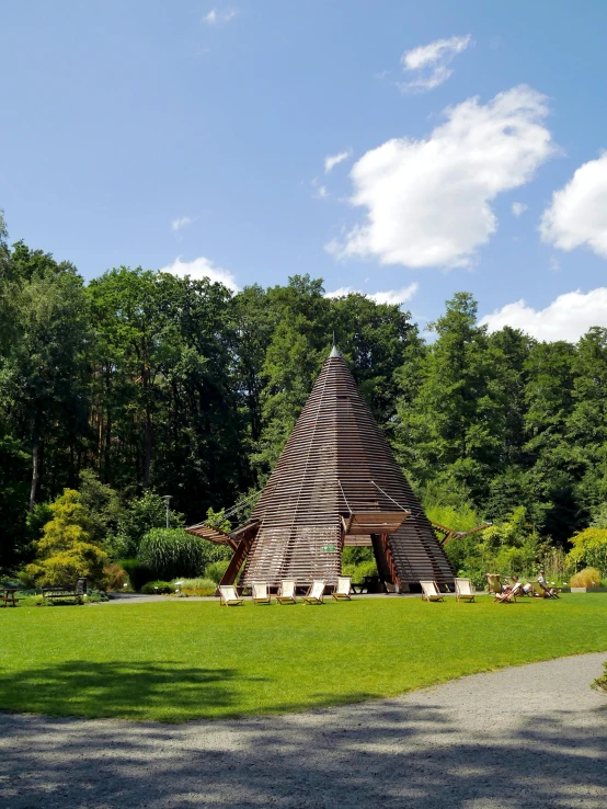 a statue in the shape of a pyramid in a field