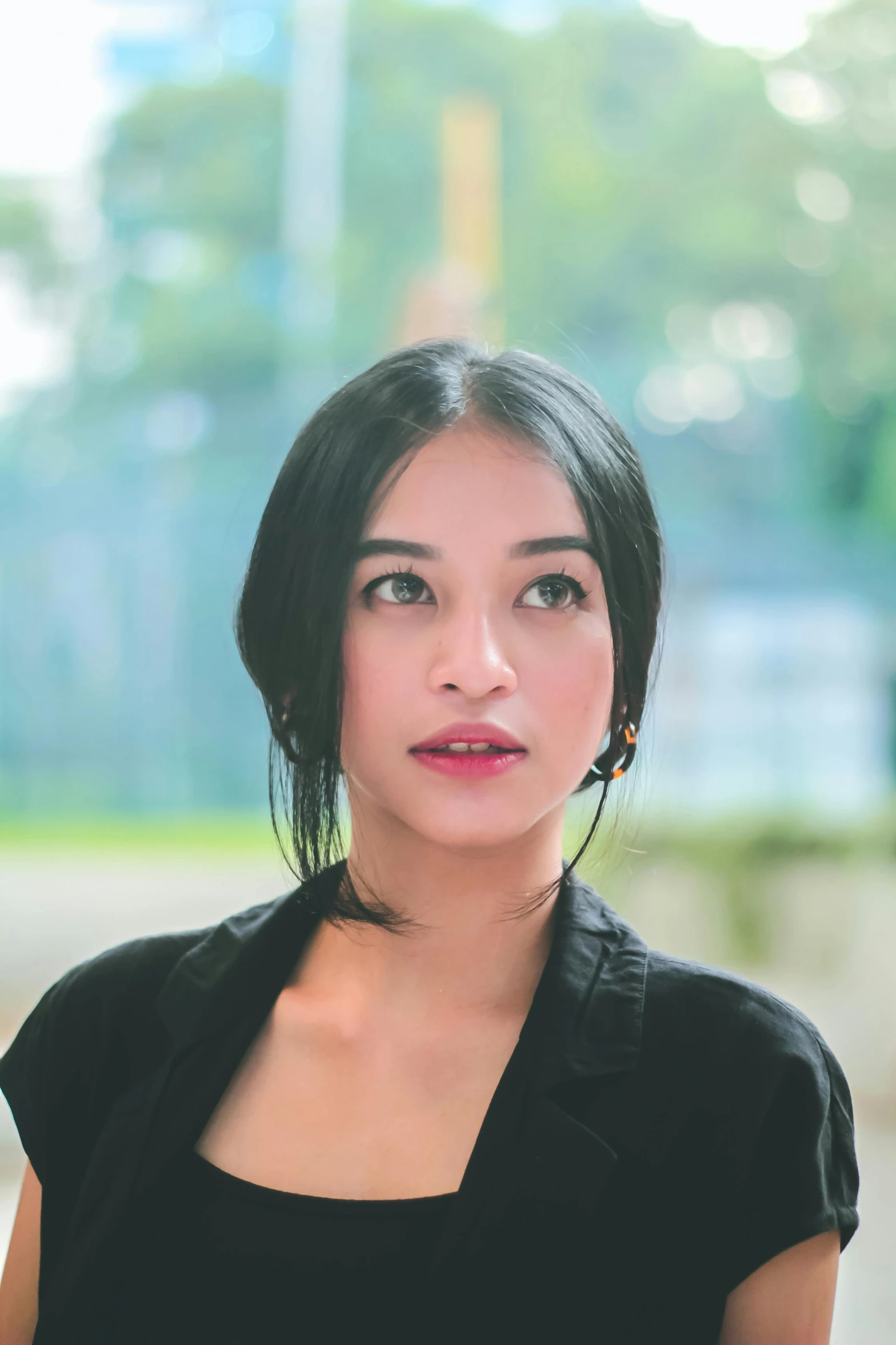 a woman in black shirt posing for a po