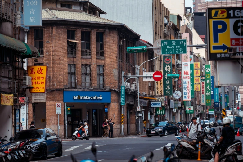 motorcycles and cars are parked on the street