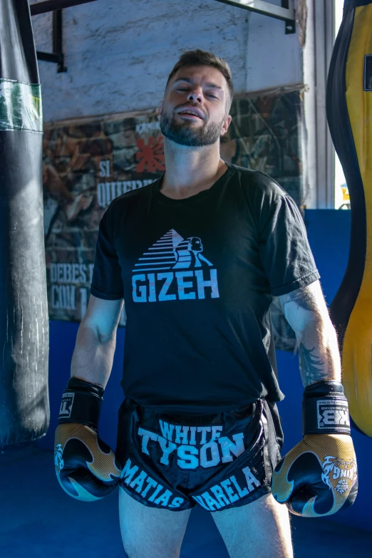 man in gloves standing next to wall at indoor venue