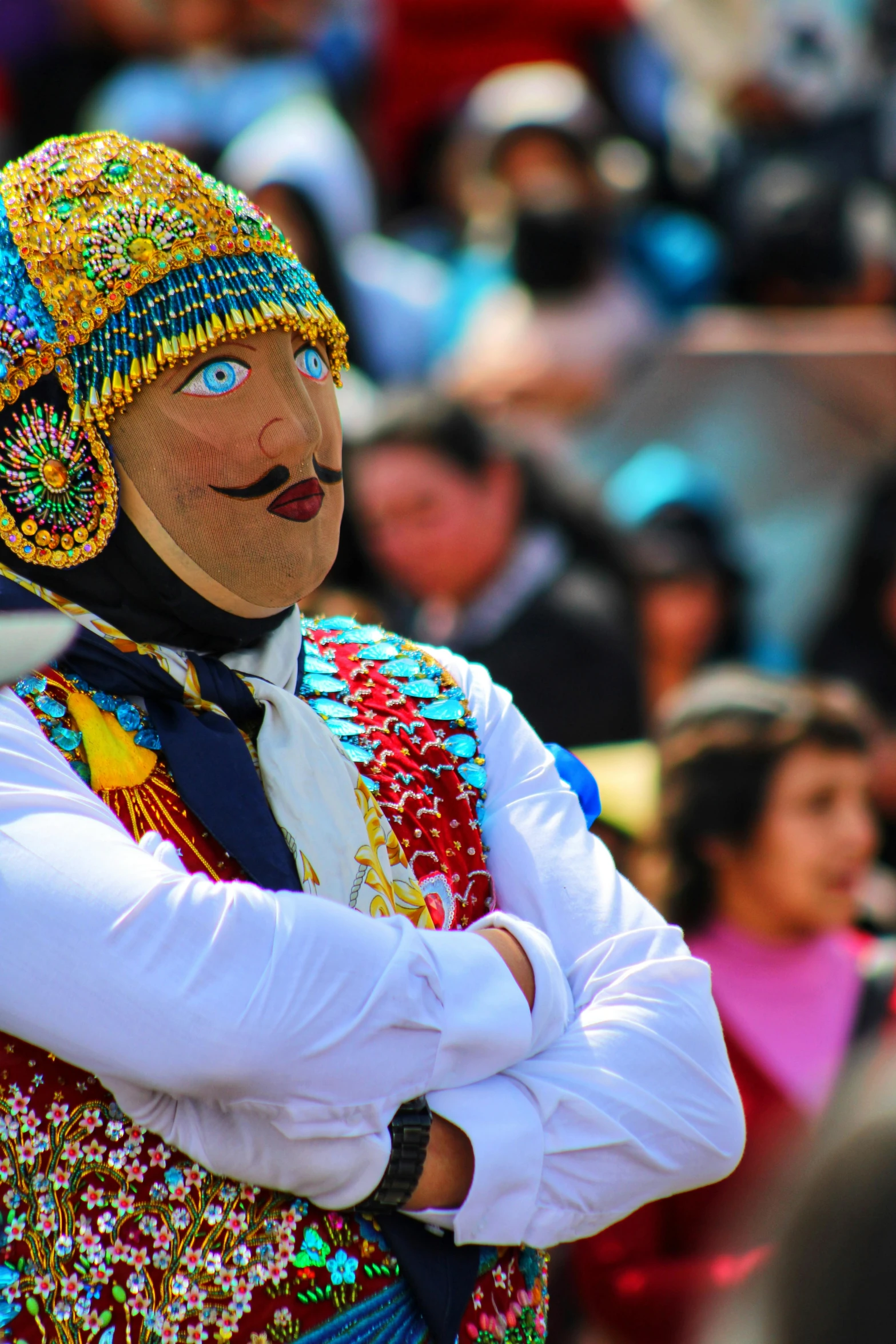 an indian performer with painted face in costume