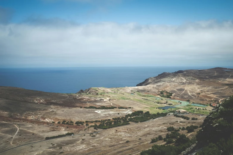 a scenic view of a large ocean with mountains and valleys