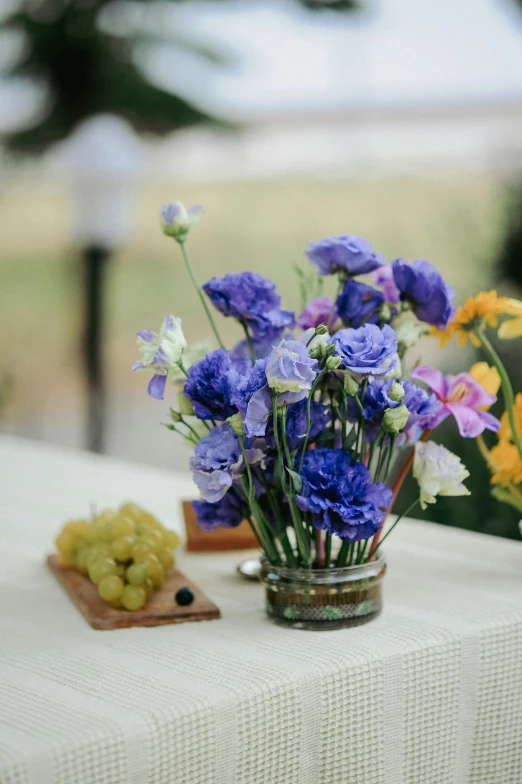 vases are sitting on a table, with assorted colorful flowers in it