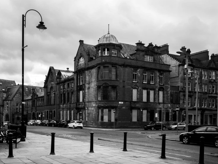 an old building on the corner with a street light on it