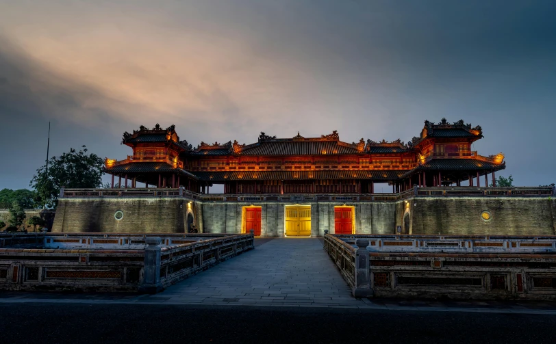 an oriental styled structure lit up at night