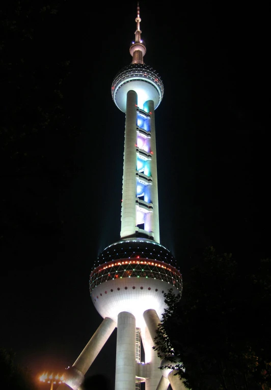 a tower with lots of lights lit up on it's sides