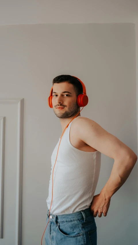 a man is wearing headphones, posing for the camera