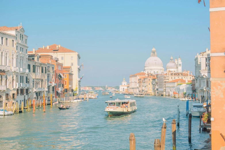 an open waterway with gondolas in the distance