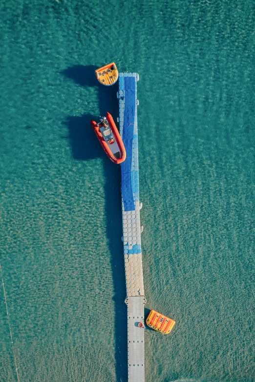 a boat sitting on top of the water near a pier