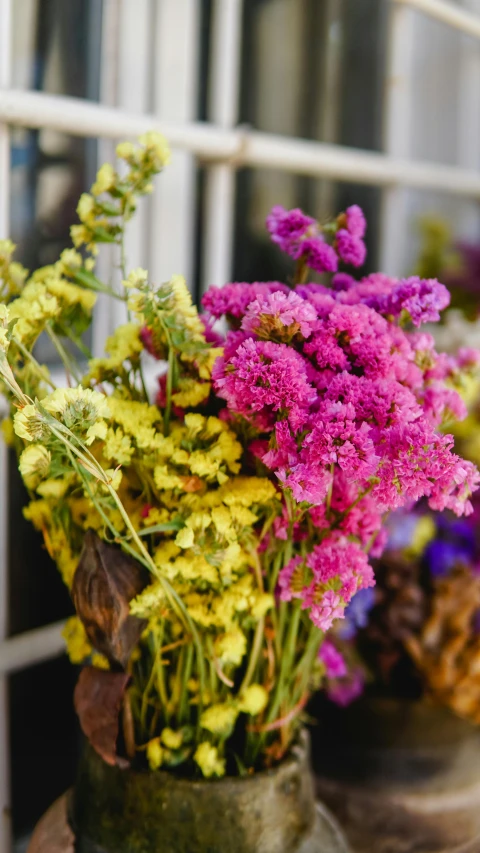 a bunch of purple and yellow flowers in a vase