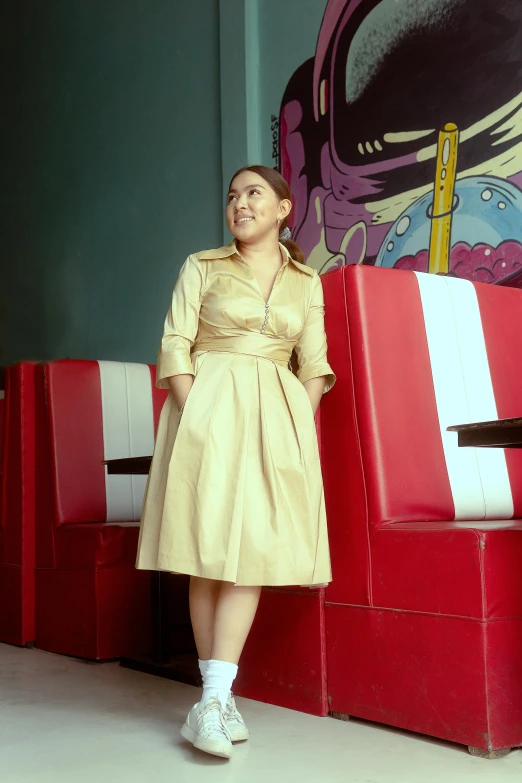 a woman is standing next to a pile of red and white cubes