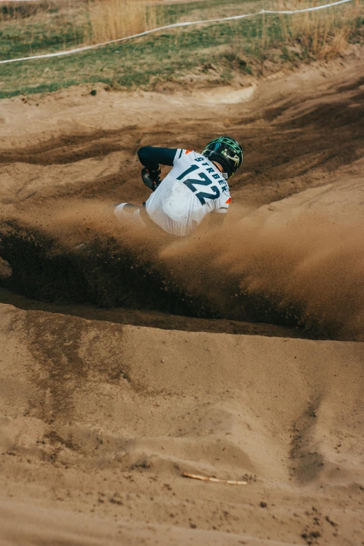 a person is riding in the sand on a motorcycle