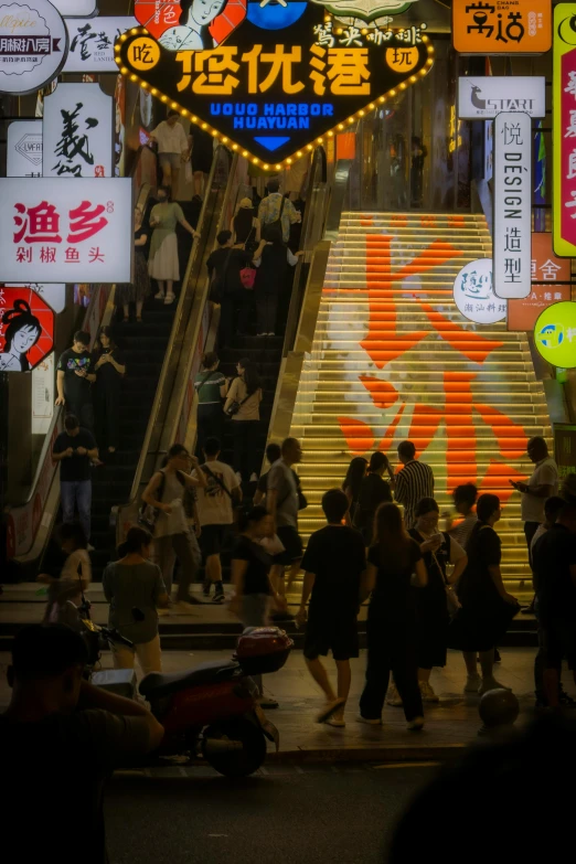 a large group of people walk down an escalator