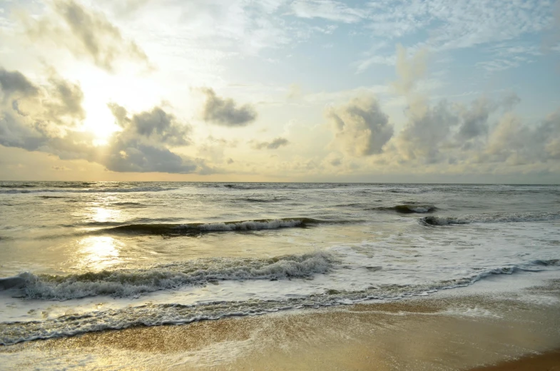 the beach is deserted and there are waves coming in