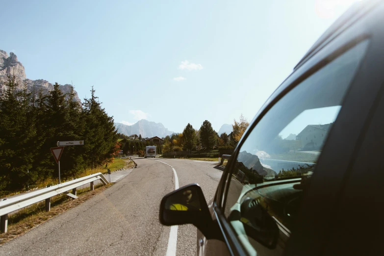 the view from the inside of a car driving on a mountain road