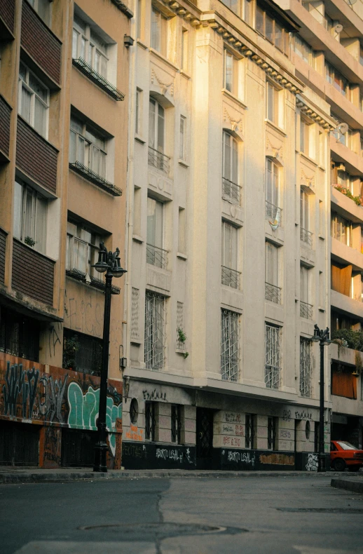 a large building near a busy street with graffiti on the walls