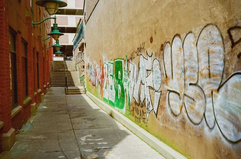 graffiti on the wall in front of a stone sidewalk