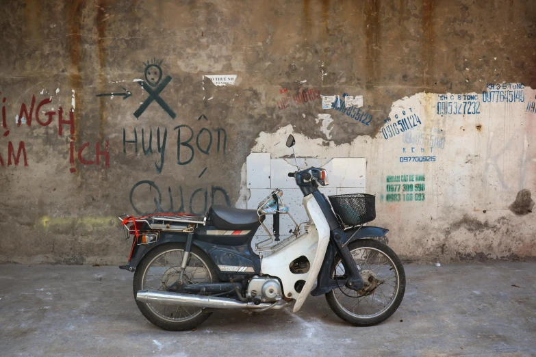 a motorcycle that is parked next to a wall