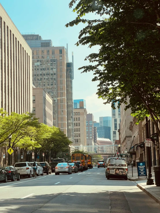 a city street with tall buildings next to a sidewalk