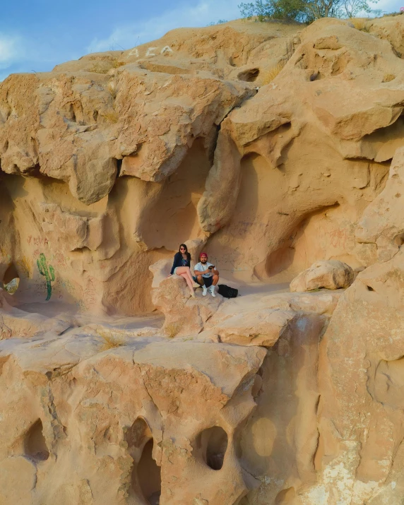 a couple sitting on top of some rocks