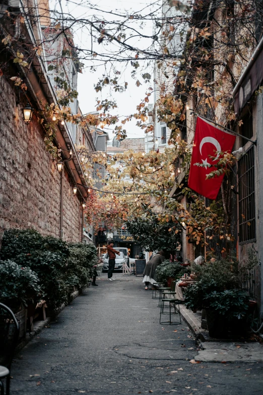 a red flag hanging in the air by several people