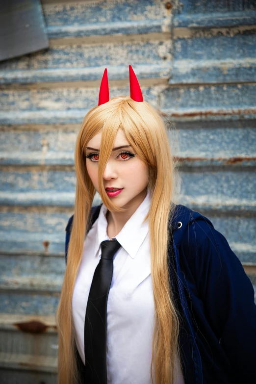 a blonde wig wearing red horns and a black tie