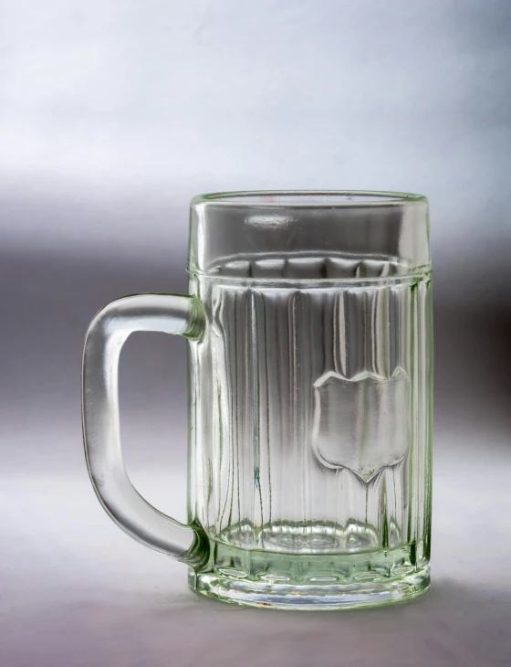 a large glass mug is empty on a surface