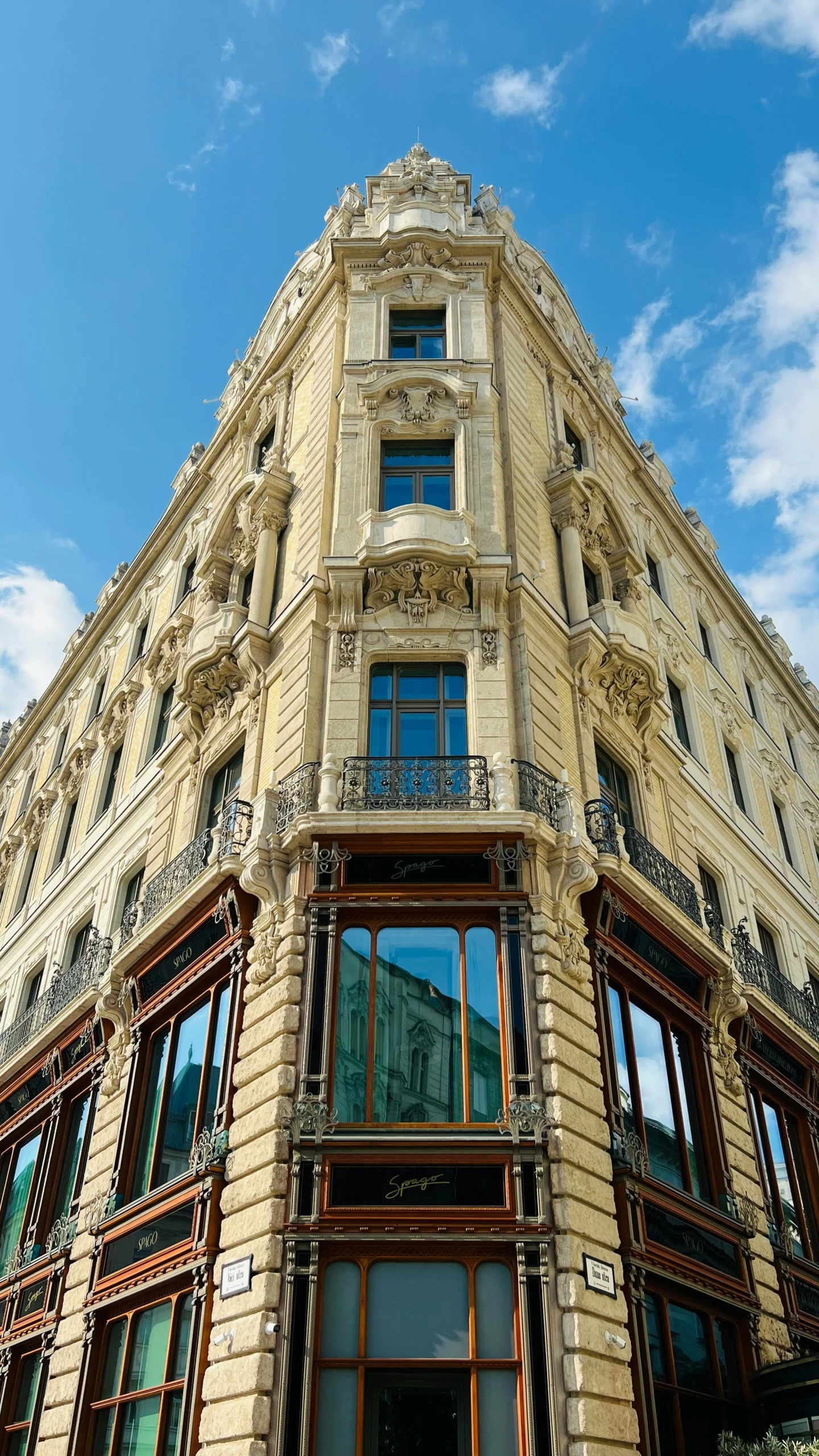 a tall building with a clock on the corner