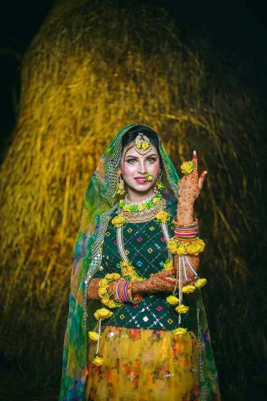 an indian woman poses with her hand painted in colors