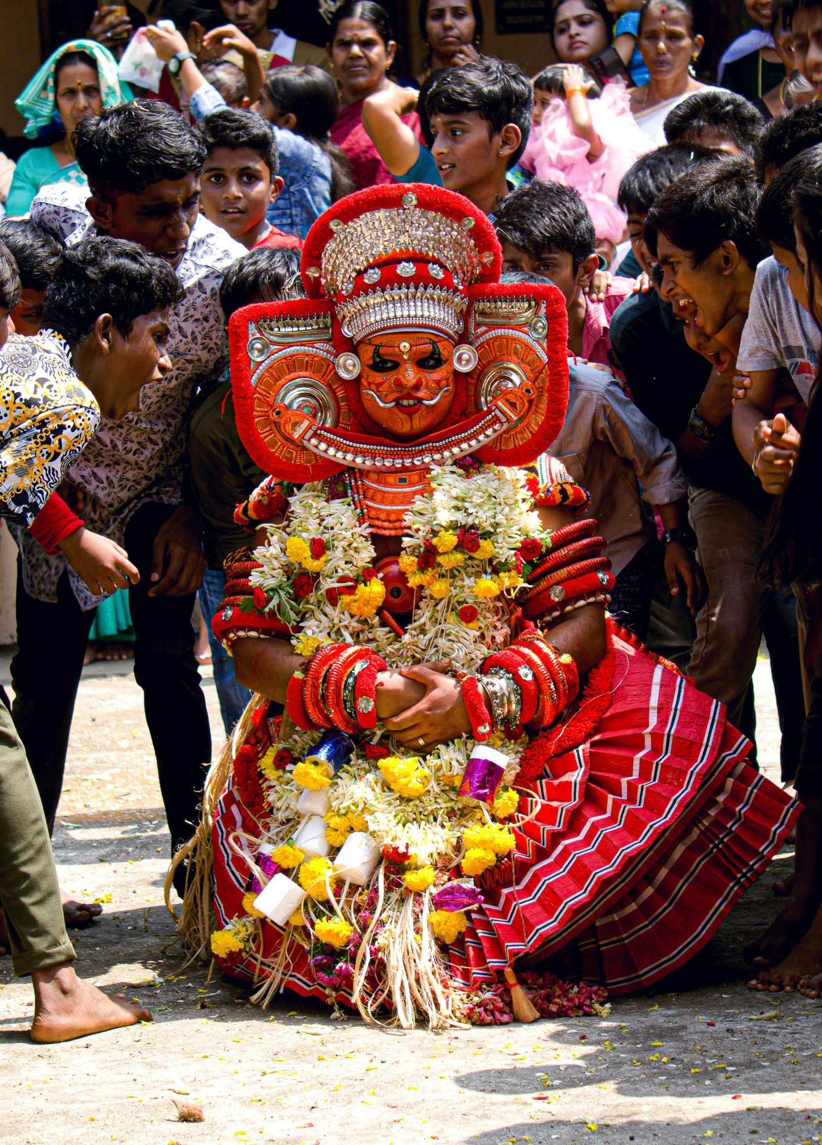 people in crowd watch a performer in elaborate costume