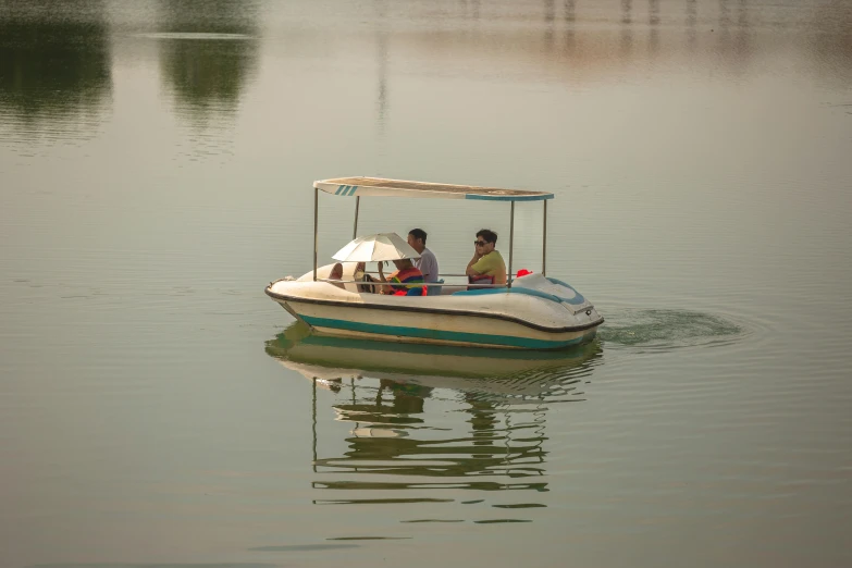 two men in a small motor boat on a river