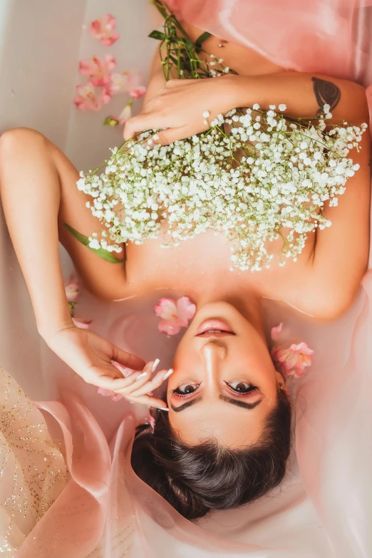a woman in a tub full of flowers