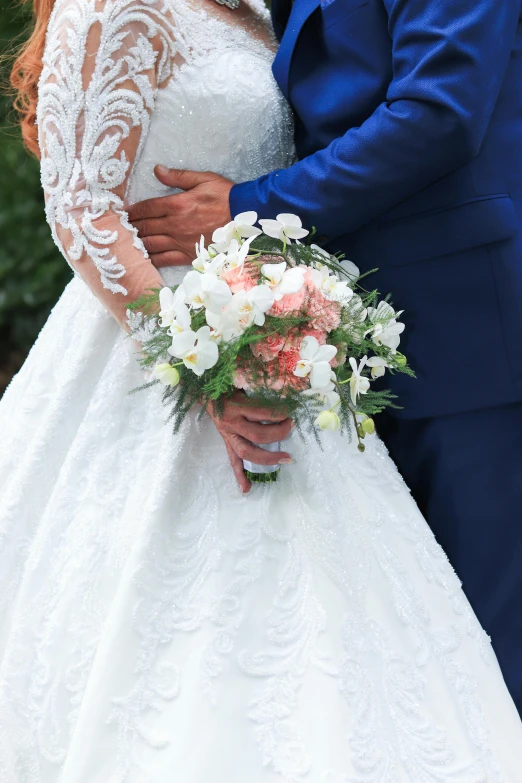 a man and woman dressed in blue, pink and white