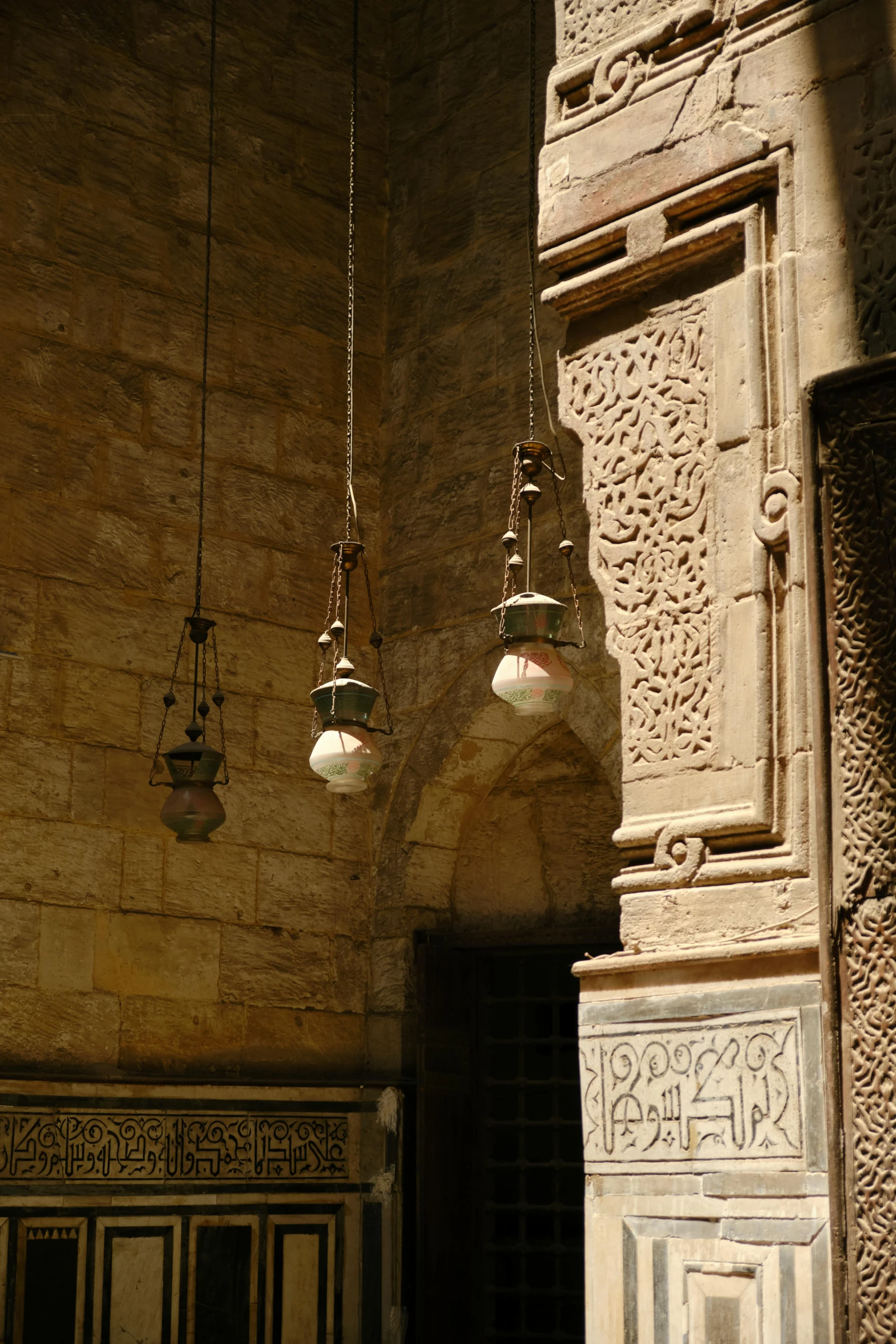 a pair of hanging lamps above a doorway